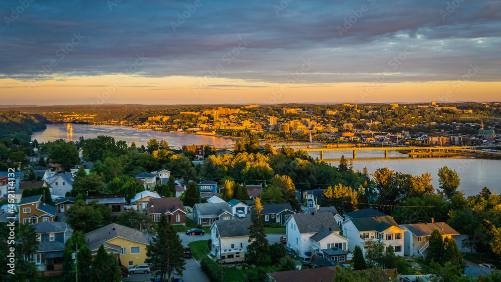 Fototapeta premium Colorful sunset and cloudy sky over the city of Chicoutimi in Quebec (Canada)