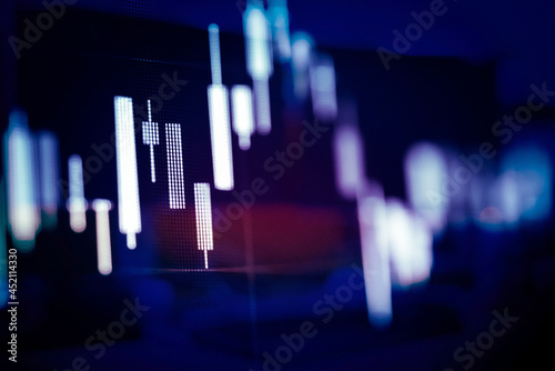 Abstract financial trading graphs and digital number of foreign exchange market trading on monitor. Background of gold and blue digital chart to represent stock market trend.  