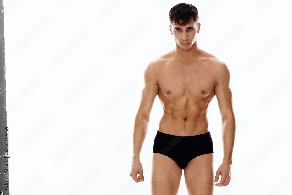 sporty man with naked body black panties light background sporty man with naked body black panties light background