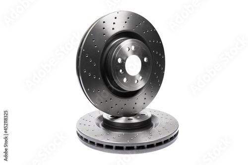 Two car brake disc isolated on white background. Auto spare parts. Perforated brake disc rotor isolated on white. Braking ventilated discs. Quality spare parts for car service or maintenance