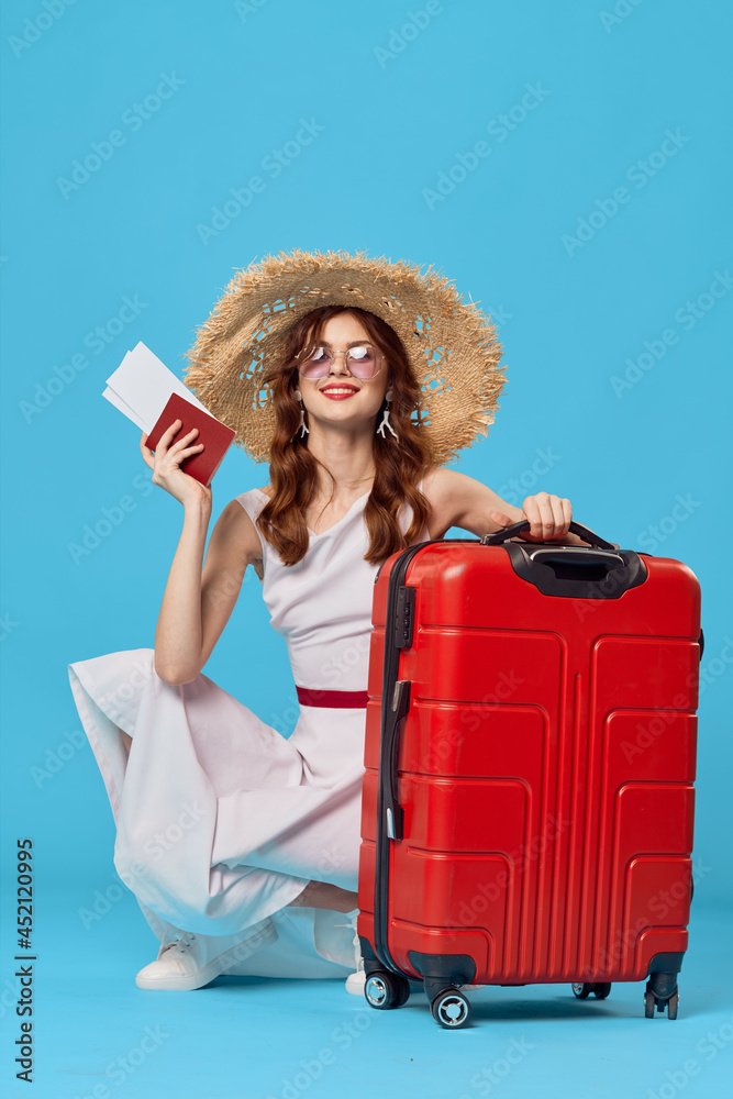 woman with red suitcase sitting on the floor blue background travel vacation woman with red suitcase sitting on the floor blue background travel vacation