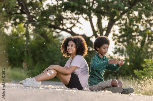 Two afro children curly hair style having fun with holiday at sunset time.Friendship and youth girlfriends vacation lifestyle concept. © kamonrat