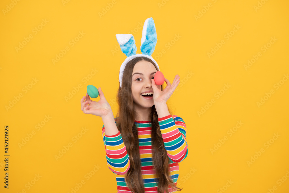 happy easter kid girl in rabbit bunny ears hold colorful eggs for holiday, egg hunt