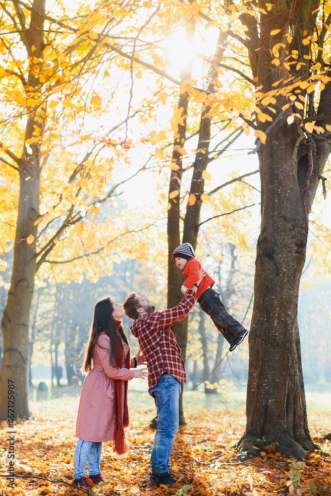 Young family walking in the park. Autumn. Young family walking in the park. Autumn.