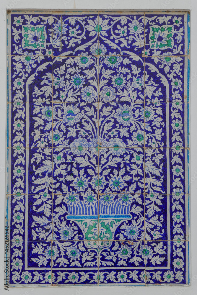 Closeup view of traditional blue and white ceramic tiles panel with floral motif on wall of Makhdum Nuh tomb in Hala, Sindh, Pakistan - obrazy, fototapety, plakaty 