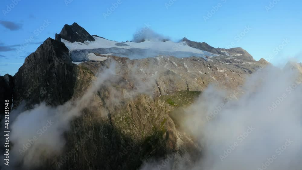 Clouds and mountains in the early morning in the Swiss Alps.