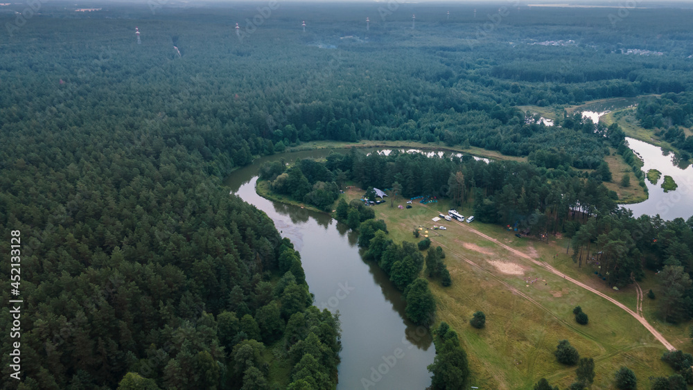 Tourist camp On The Bank Of A forest River. Aerial view. Adventure concept.