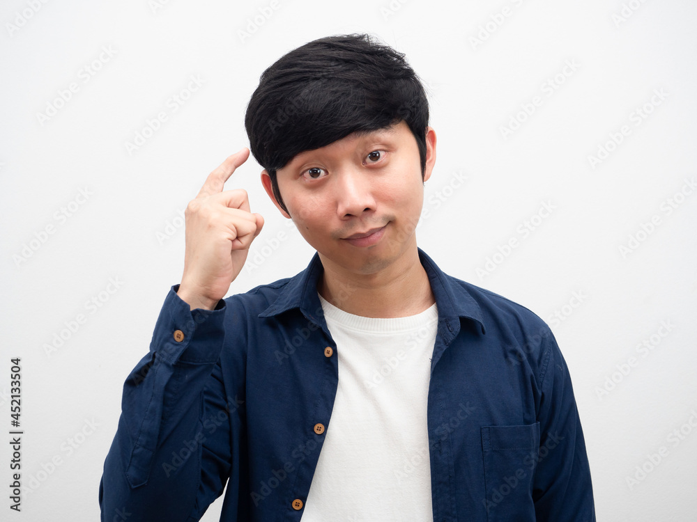 Young man point finger at his head gesture thinking portrait white background Young man point finger at his head gesture thinking portrait white background
