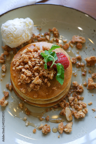 Close up Vanilla crumb pencakes with ice cream and topping strawberry. Top view