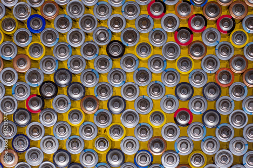 alkaline batteries on top of each other on a yellow background