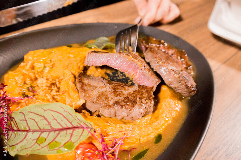 Fototapeta premium Meat steak on a plate with mashed potatoes