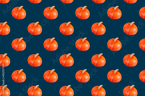seamless pattern of orange pumpkin on dark blue color 
