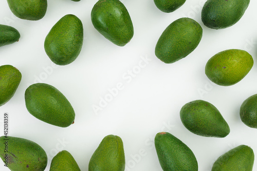 Avocado fruit frame on white background. Flat lay, top view