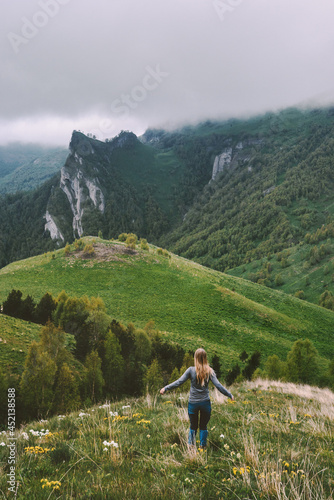 Woman traveling alone enjoying foggy mountains view hiking adventure vacations outdoor healthy lifestyle active trip