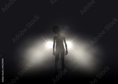 Alien in car headlights on foggy night