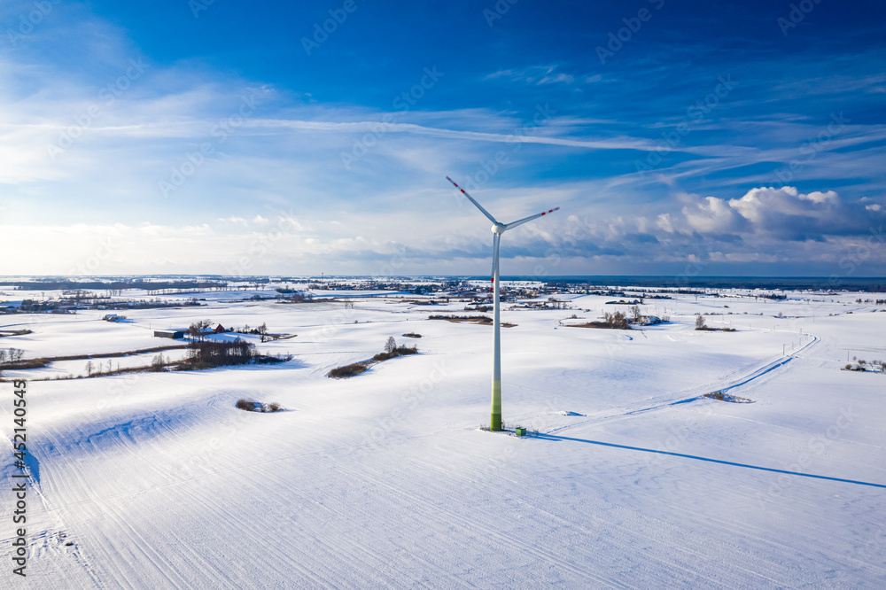Wind turbine on white field. Alternative energy in winter. Wind turbine on white field. Alternative energy in winter.
