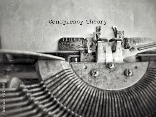 Social Issues Concept - Conspiracy Theory text in vintage background. Stock photo.