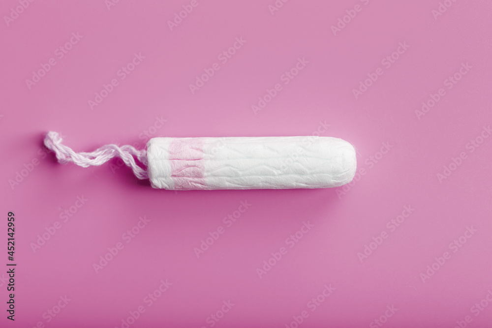 Hygienic tampon on a pink background with a free space Hygienic tampon on a pink background with a free space