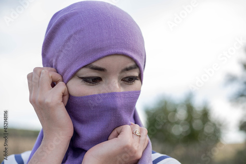 An Afghan woman with downcast eyes in a hijab. Women in Kabul are forced to wear a hijab and a burka. The rise to power of the Taliban. Violation of women's photo