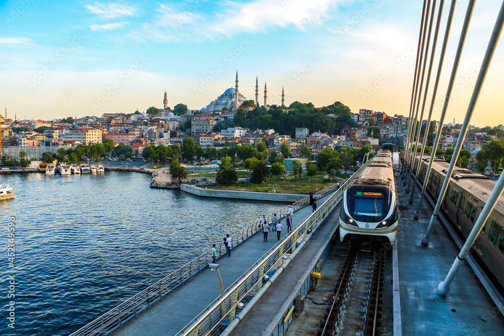 Naklejka premium selective focus, 26.06.2021 ISTANBUL, Turkey: Eminonu Golden Horn metro, silhouettes of istanbul mosques from the metro station bridge