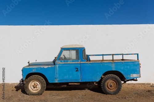 Landrover parked against a building on the sand in La Graciosa Spain