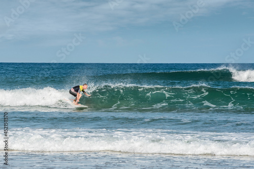 middle aged surfer in action in the waves © Image'in