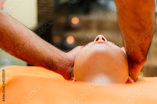 An attractive latin american woman lying down on a massage bed at a spa
