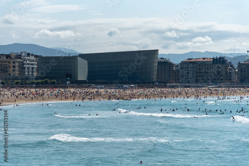 Vista de la playa de la zurriola en San Sebastian en un dia de verano con gente bañandose photo
