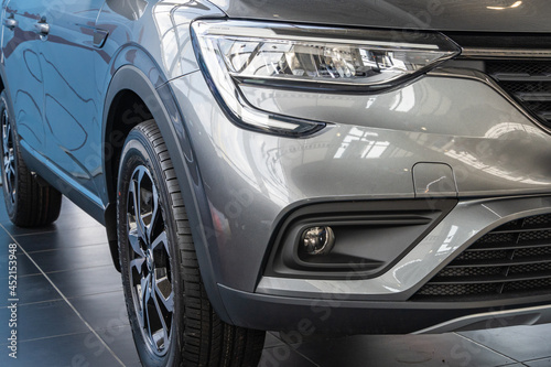 Renault Arkana gray SUV at Renault showroom. Close-up of right headlight  right front fog lamp and right front wheel. Renault car dealership in Mega Adygea. Krasnodar  Russia - August 17  2021