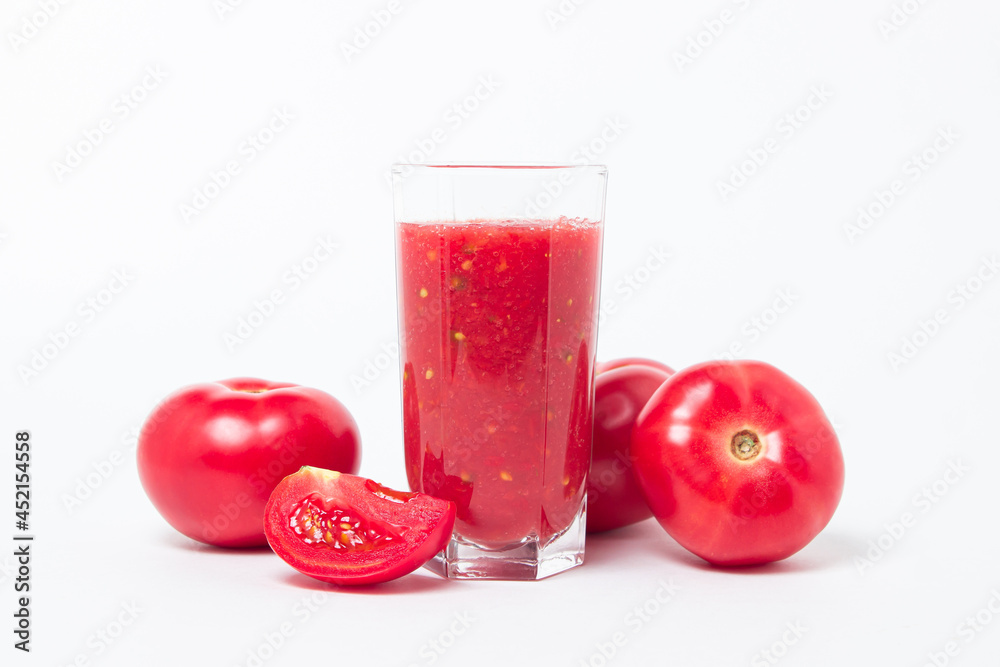 A glass of tomato juice on a white background. Natural freshly squeezed tomato juice. A glass of tomato juice on a white background. Natural freshly squeezed tomato juice.
