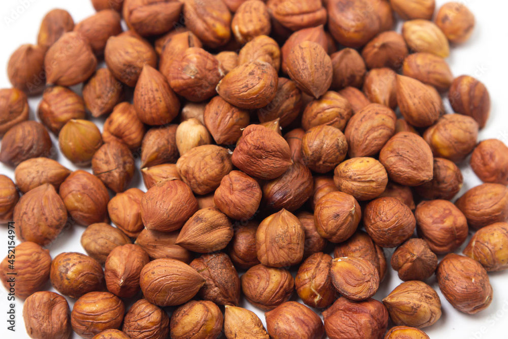 Peeled hazelnuts on a white background. Healthy diet Peeled hazelnuts on a white background. Healthy diet