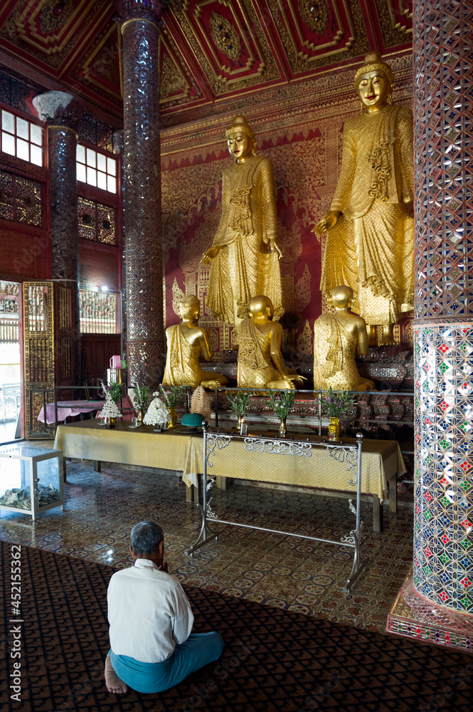 Myanmar (formerly Burma). Mon State. Kadoe. The U Na Auk Pagoda complex. Man praying at temple