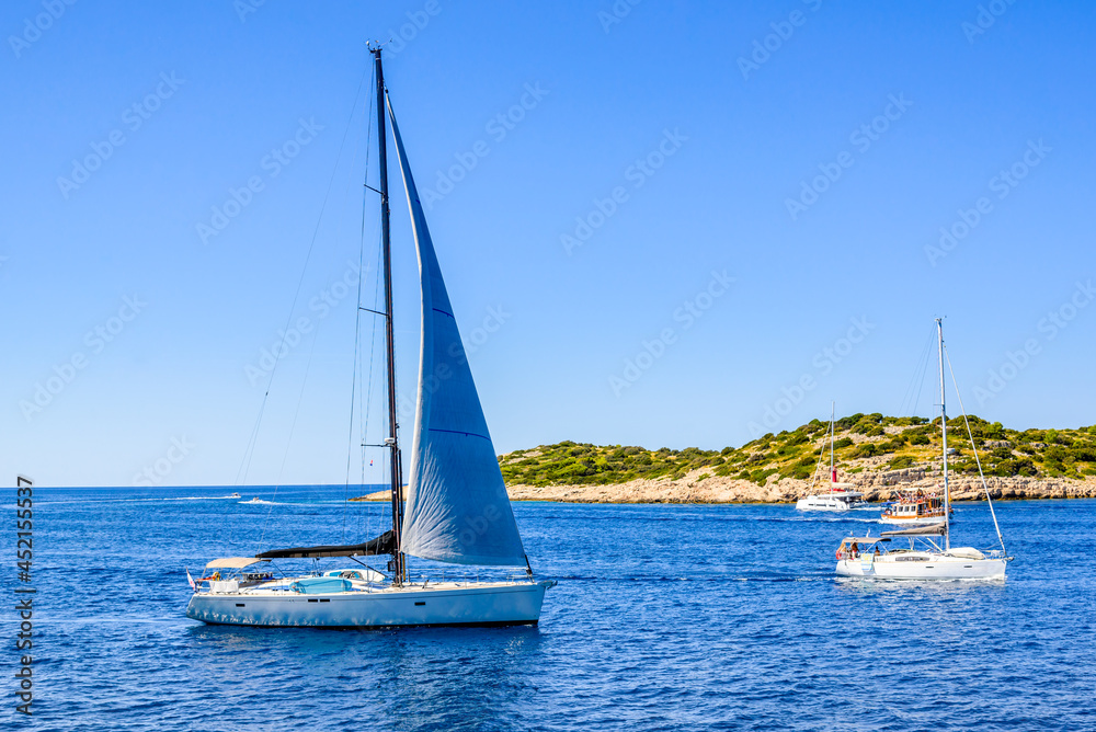 Obraz premium Sailing yacht with white sail sailing in the sea, Croatia
