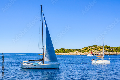 Fototapeta Naklejka Na Ścianę i Meble -  Sailing yacht with white sail sailing in the sea, Croatia