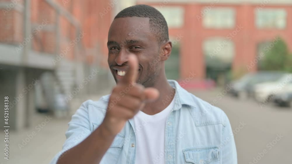 Outdoor Portrait of African Man Pointing at the Camera Outdoor Portrait of African Man Pointing at the Camera