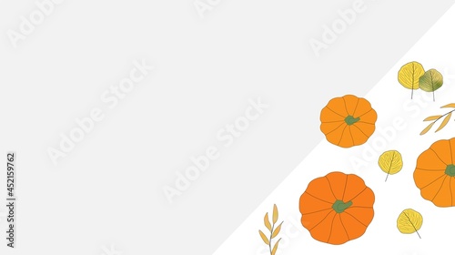Bright colored autumn leaves and orange pumpkins in bottom right corner with copy space on grey background. Fall, seasonal. Thanksgiving.