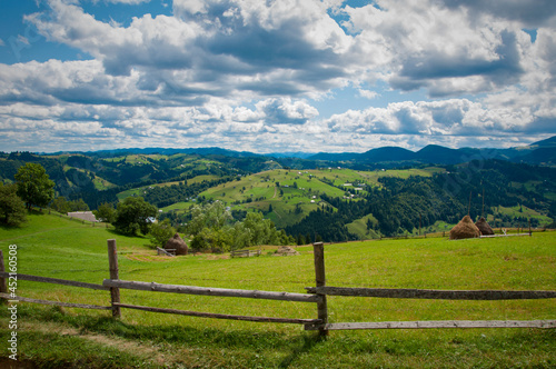 composite summer landscape, fence along the hillside meadows of the mountains. High quality photo