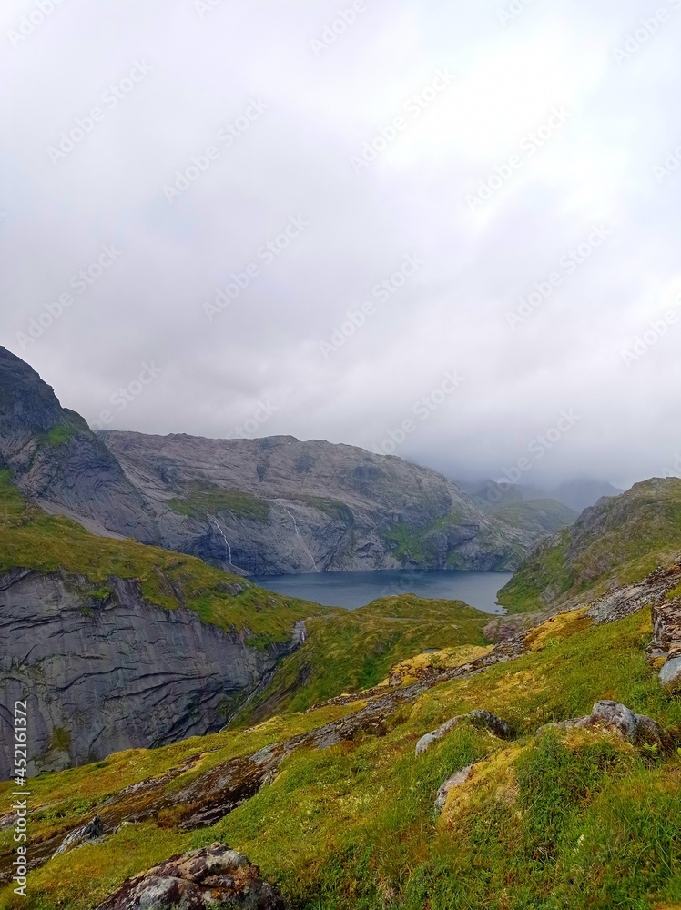 Munkebu hut hiking trail during arctic summer in mountains of Lofoten, Norway, Nordland Munkebu hut hiking trail during arctic summer in mountains of Lofoten, Norway, Nordland