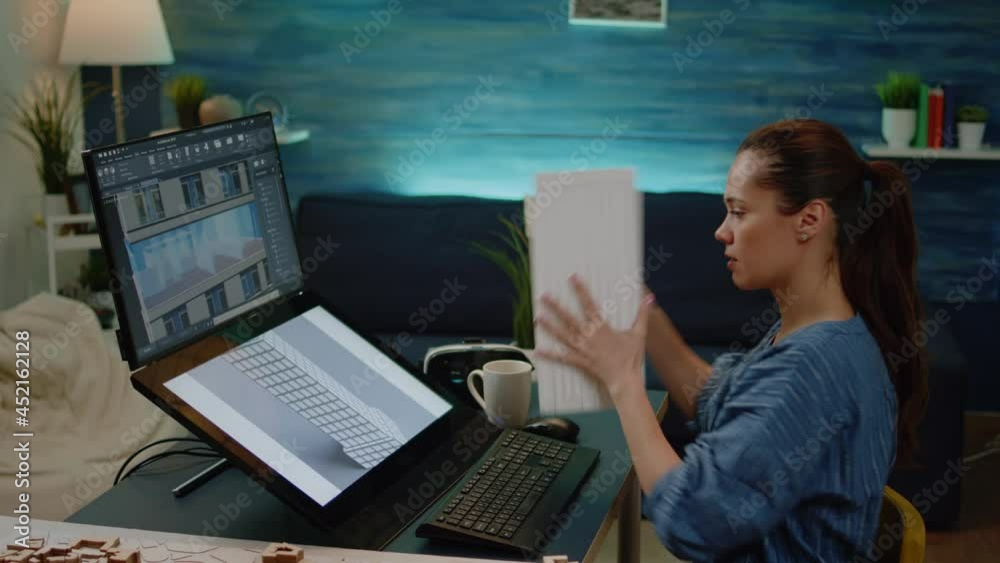 Young engineer designing building model for construction layout in ...