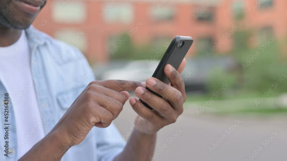 Close up of African Man Using Smartphone, Outdoor Close up of African Man Using Smartphone, Outdoor