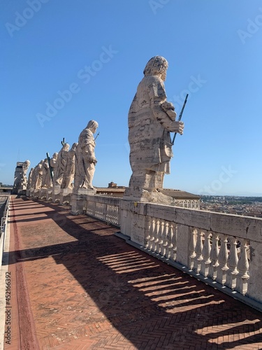 White marble, stone statues, sculptures on the roof of Saint Peter's Basilica church. Panoramic view of Roma city. Vatican city, Vatican, Rome, Italy.