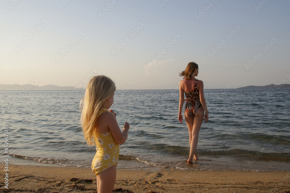 Mother and her toddler girl enjoying a day at the beach Mother and her toddler girl enjoying a day at the beach