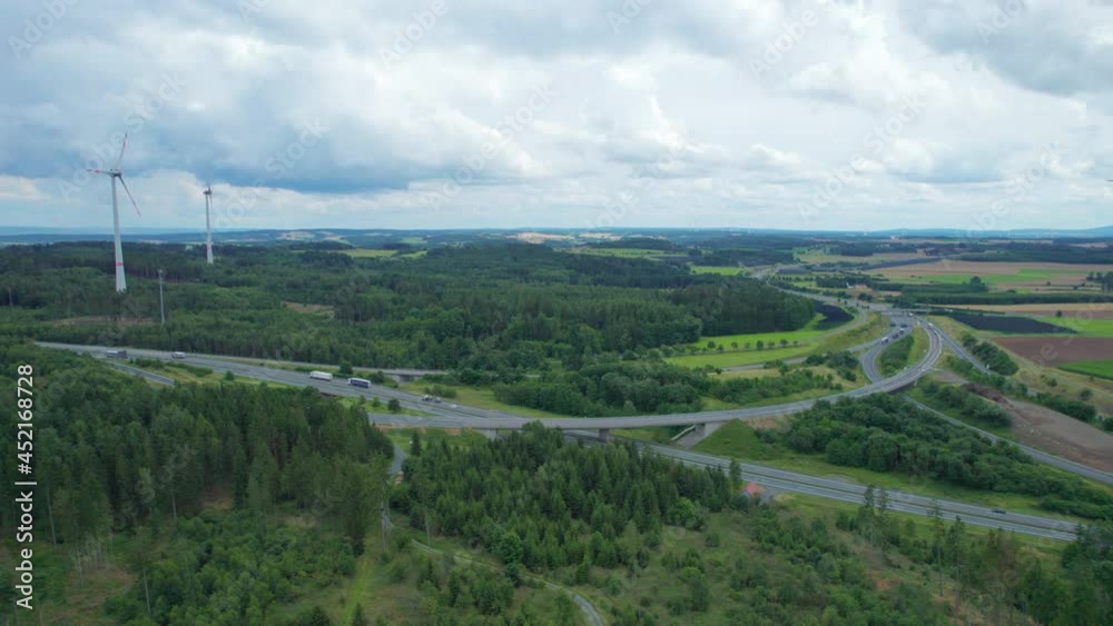 farm with wind turbines near the highway road interchange (aerial) farm with wind turbines near the highway road interchange (aerial)