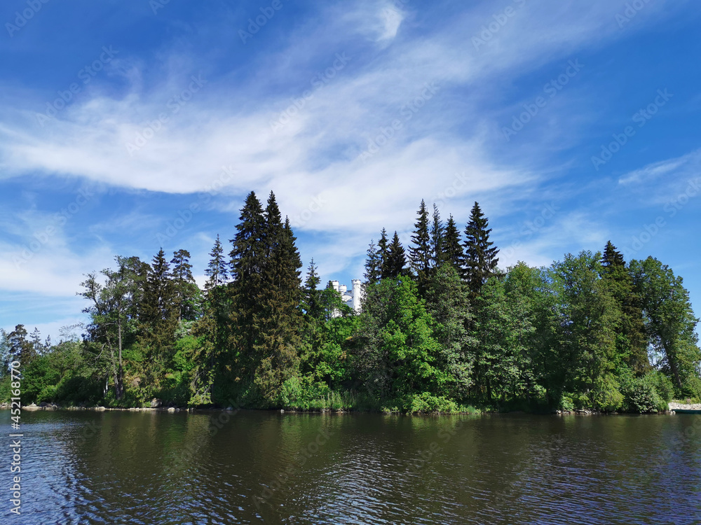 Obraz premium View from the shore of the Vyborg Bay to the island with a Chapel in the Monrepos rock Natural Park of the city of Vyborg.