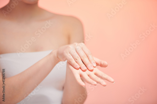 Girl hands applying moisturizing cream to her skin