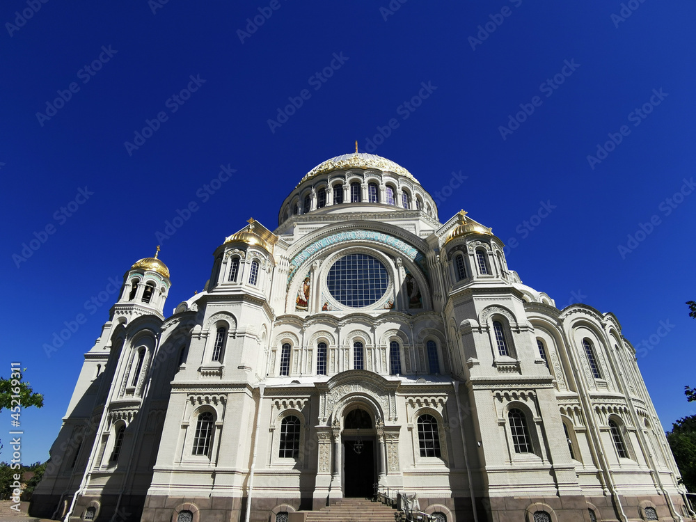 Bottom view of the St. Nicholas Cathedral on the background of a cloudless sky, on a summer day in Kronstadt. Bottom view of the St. Nicholas Cathedral on the background of a cloudless sky, on a summer day in Kronstadt.