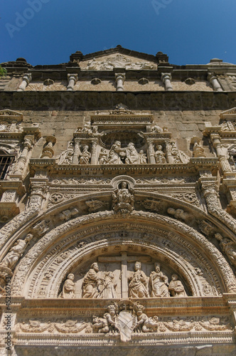 Old church entrance decoration with figures | Malaga, Spain