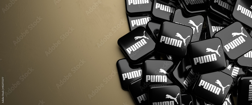 Logos of the German sportswear and apparel company Puma SE on a heap on a  table. Copy space. Web banner format. Stock Photo | Adobe Stock