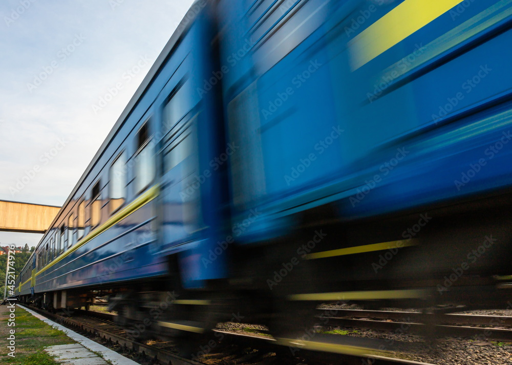 Naklejka premium a blue passenger train travels along the track