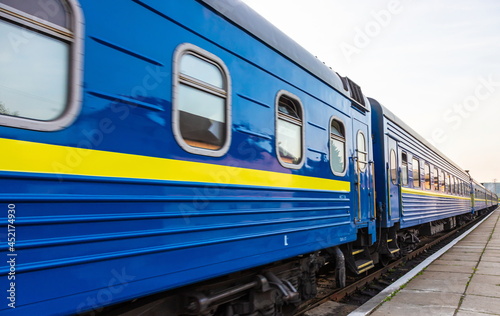 a blue passenger train travels along the track